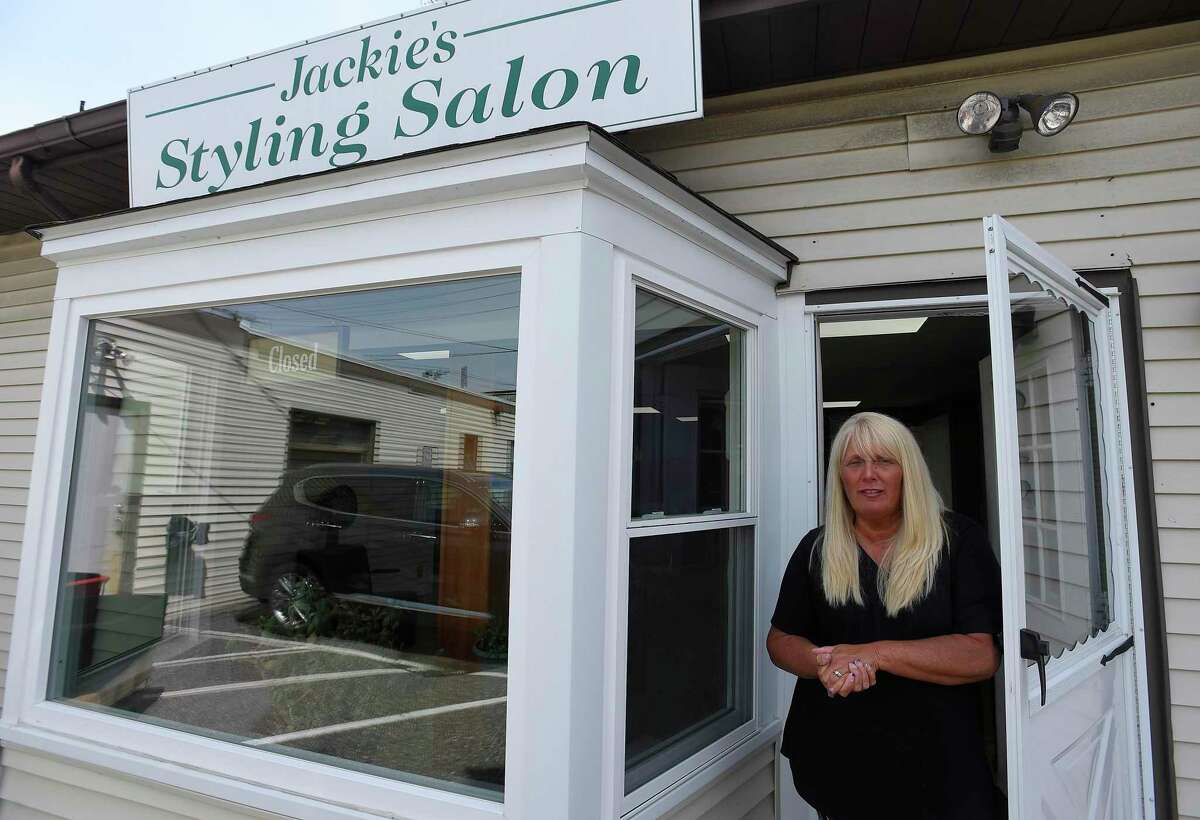Jackie Dudek, who owns and operates Jackie's Styling Salon, is one of more than 3,000 hair salon owners statewide who are questioning why hair salons are allowed to open May 20 when tatoo parlors, nail salons, message therapists and other close-in service providers must stay closed. Everyone wants to open, Dudek says, but it's not safe yet. She has to weigh losing clients to those that do open to keeping herself, her employees and her clients safe, Dudek says. She is photographed on May 16, 2020 at her salon in the Glenbrook neighborhood of Stamford, Connecticut.