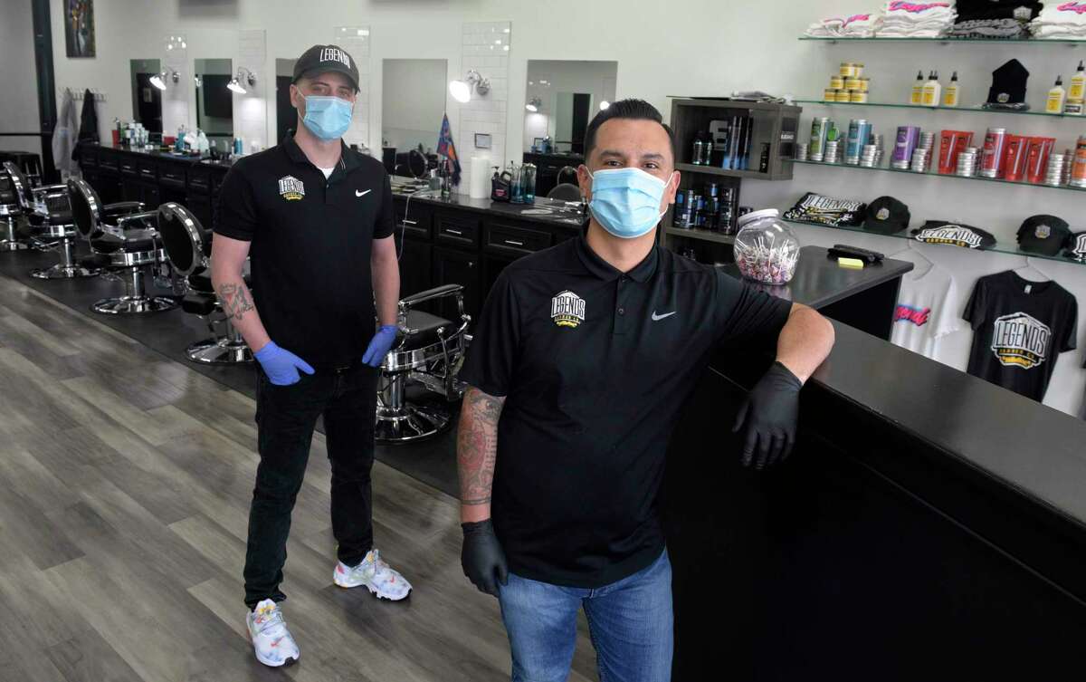 Pat Kelly, left, and Andres Jimenez, co-owners of Legends Barber Co., in their Danbury shop. Friday, April 8, 2020. On Monday, Lamont delayed the reopening of hair salons and barbershops to June 1, just two days before the scheduled restart.