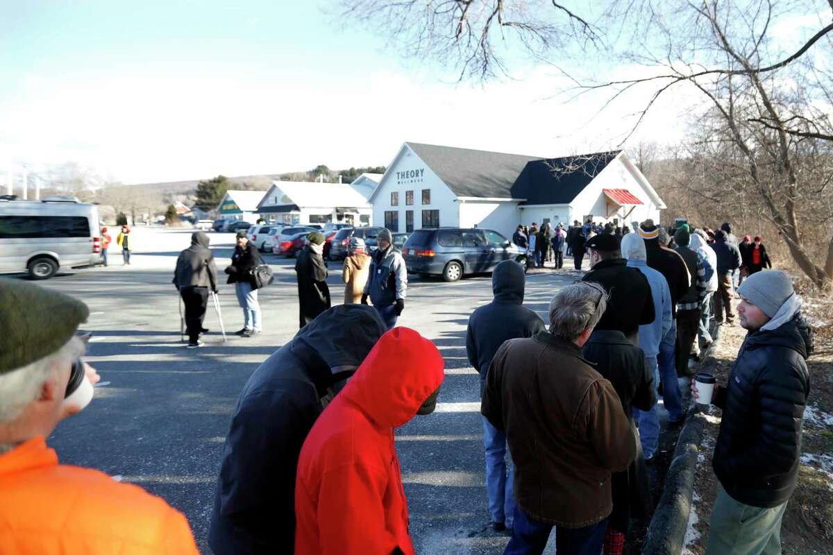 Customers wait on line in the cold on the opening day of recreational marijuana sales at Theory Wellness in Great Barrington, Mass., Friday, January 11, 2019. Theory is the first dispensary in the Berkshires to open its doors for recreational marijuana sales and the opening makes Theory the 6th dispensary of its kind in the state. (Stephanie Zollshan/The Berkshire Eagle via AP)