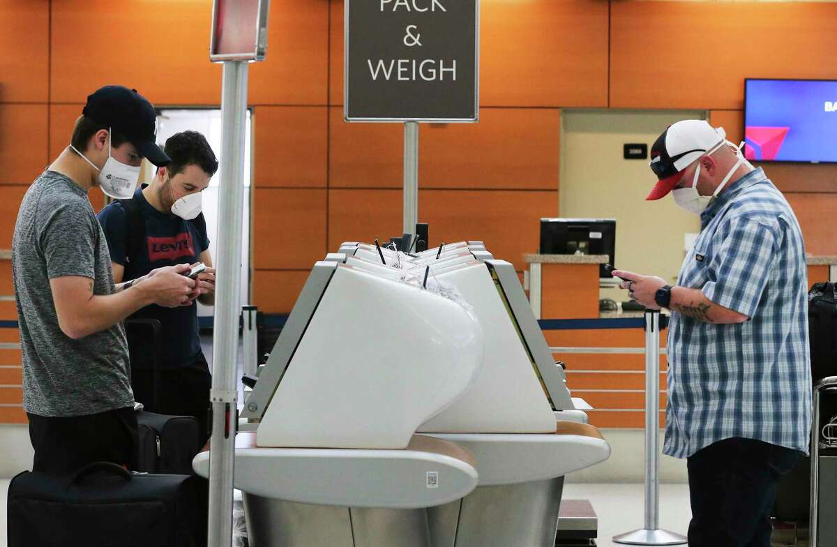 Travelers check-in on kiosks at the Delta ticket counter on Monday, May 18, 2020. Travelers at San Antonio International Airport are still a fraction of the numbers pre-COVID-19 but the few who are traveling by plane are often essential workers or coming to aid of loved ones. Data shows there has been a slight pickup of passengers as stay at home orders have been limited.