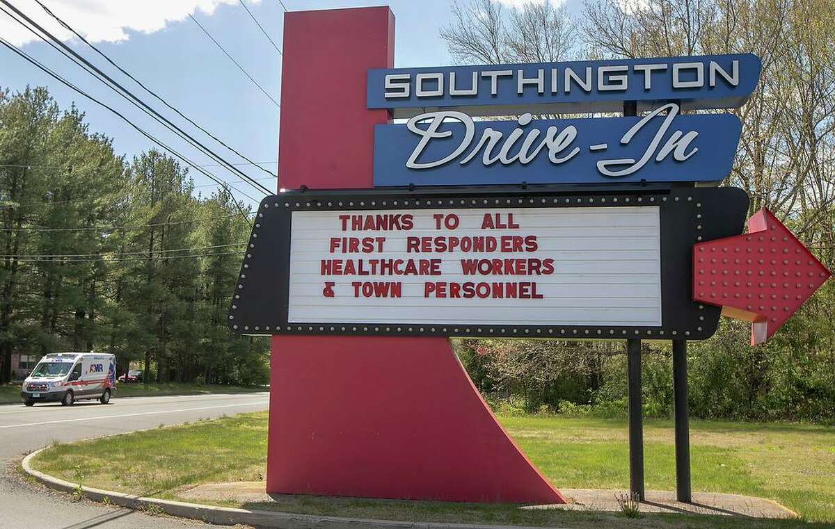 In this Tuesday, May 12, 2020, photo, the Southington Drive-In displays a message to first responders, healthcare workers and town personnel as an ambulance heads to a call on Meriden Waterbury Turnpike in Southington, Conn. (Dave Zajac/Record-Journal via AP)