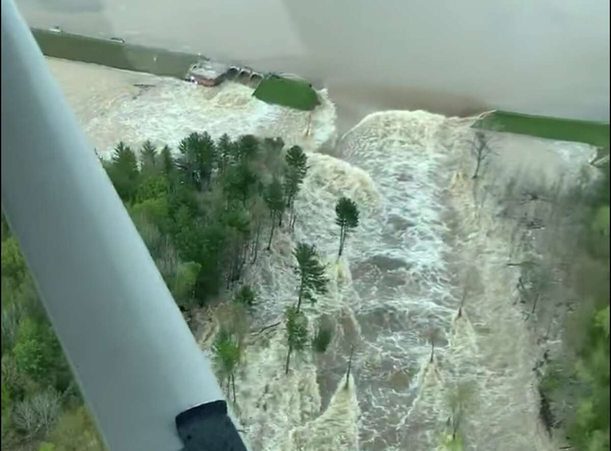 The Tittabwassee River spills over the damaged Edenville Dam in this screenshot of video shot by Ryan Kaleto on Tuesday, May 19 2020.