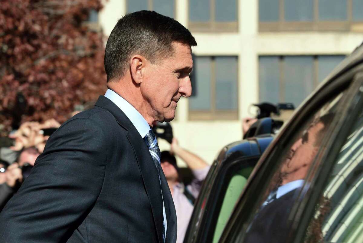 FILE - In this Dec. 1, 2017, file photo, former President Donald Trump national security adviser Michael Flynn leaves federal court in Washington. The Justice Department's dismissal of the Michael Flynn case has been swept up in a broader push by President Donald Trump and Republican allies to reframe the Russia investigation as a plot to sabotage his administration. (AP Photo/Susan Walsh, File)