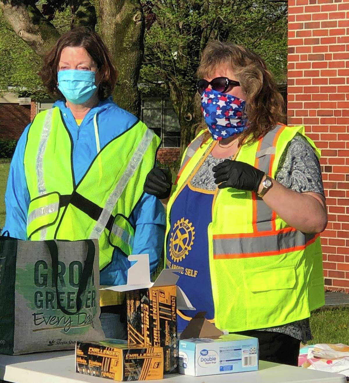Rotarians Sharon Ward, left, and co-coordinator of the event Lori Gordon, oversee the tables to replenish stock.