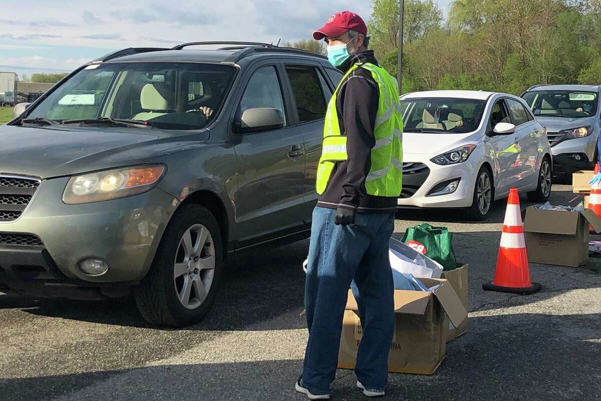 Rotary President Brad Kamp assesses the flow of traffic through the giveaway line.