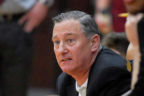 Trinity Catholic coach Brian Kriftcher follows the action on the court in a boys basketball game against St. Joseph last season in Stamford.
