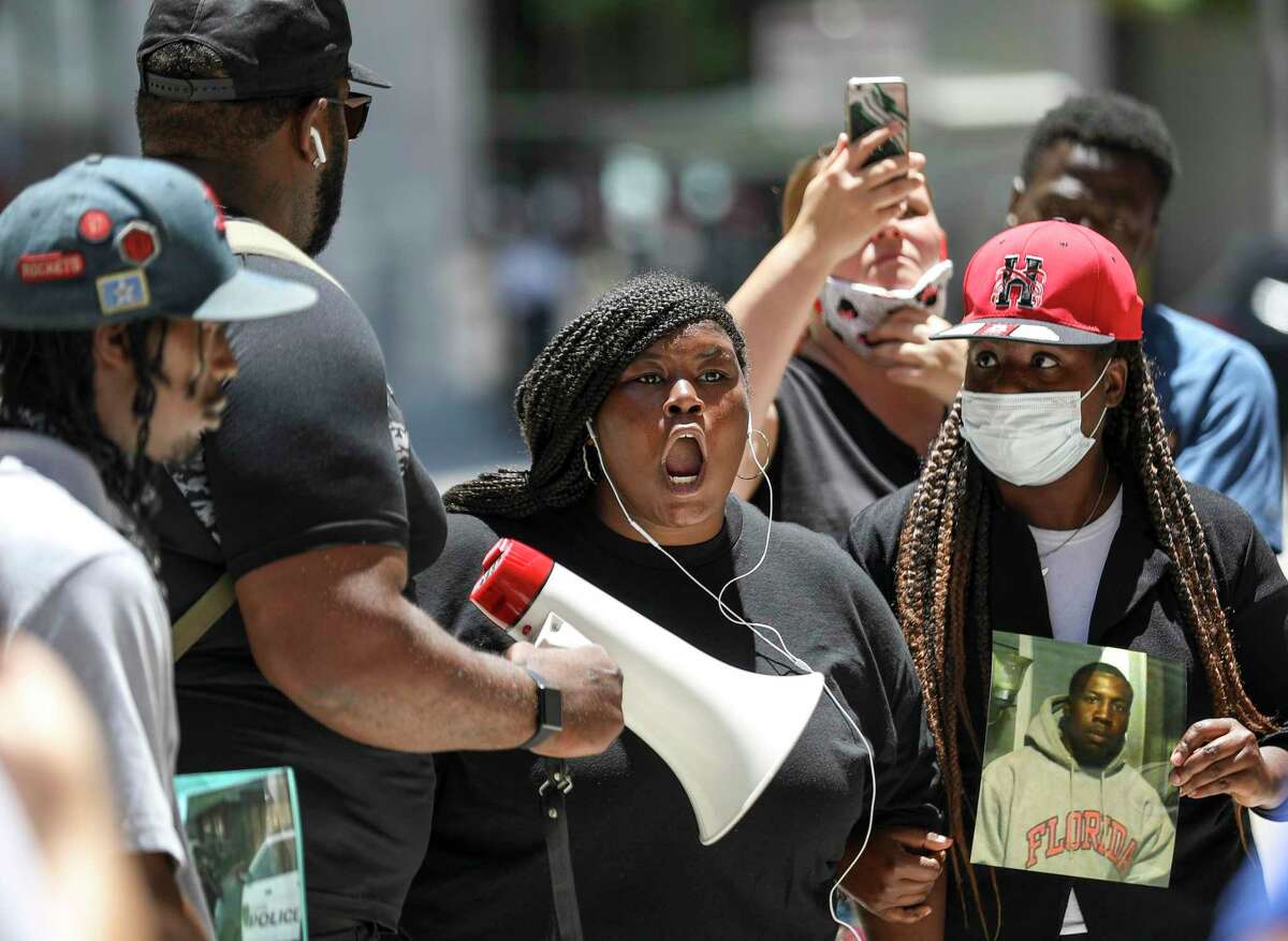 Nakia Emmitt yells at Houston Police officers during a protest over the recent shooting death of her boyfriend, Rayshard Scales, on Monday, May 18, 2020, at HPD headquarters in Houston. Emmitt said she was on the phone with Scales when he was shot by police at a bus stop near the intersection of Scott Street and Corder Street. Scales later died at the hospital. The fatal shooting was one of at least five involving Houston police since April 21. "I'm not used to him not being here no more," Emmitt said. "I want justice, and I'm not gonna stop until I get it."