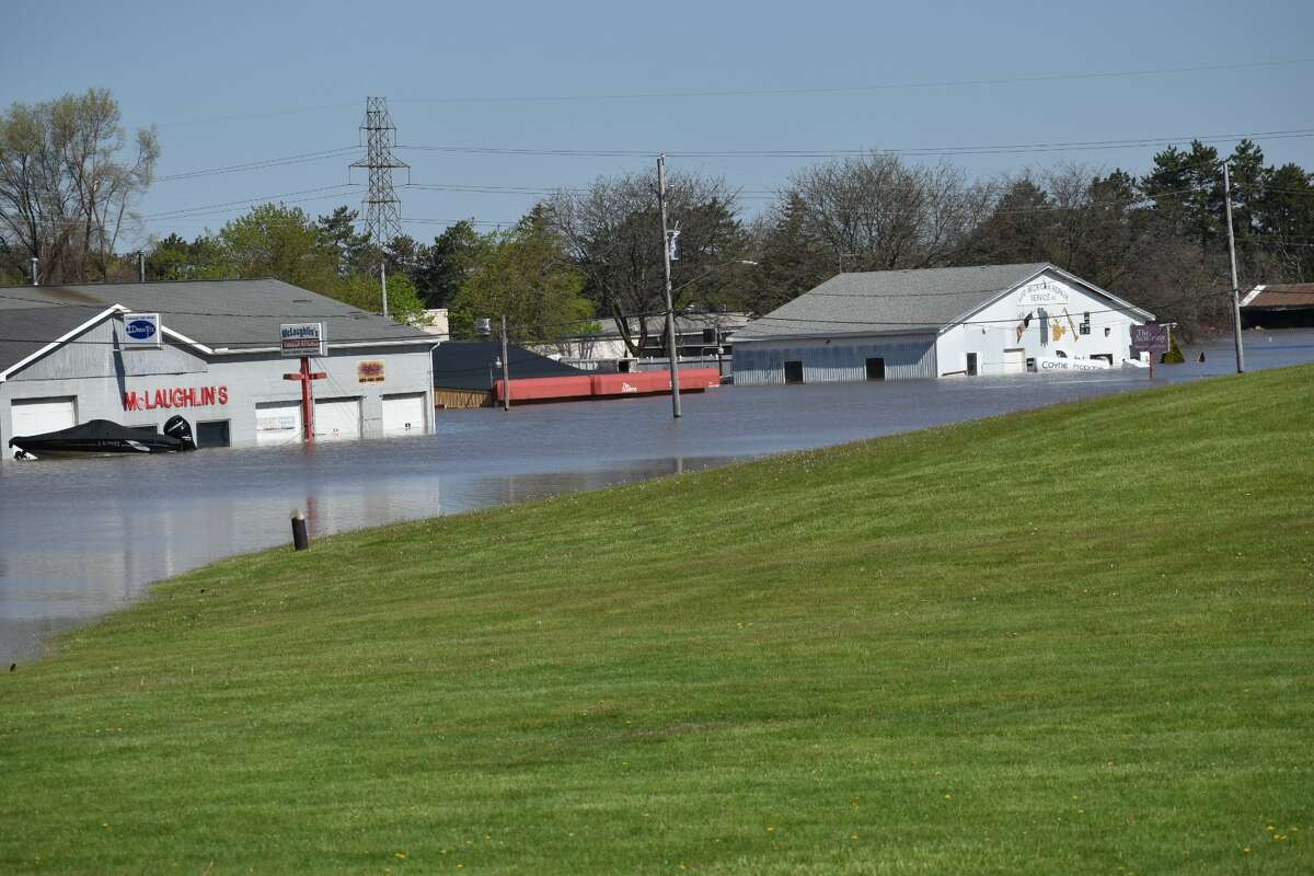 Flood water rises along Poseyville Road as the Tittabawassee River floods Wednesday, May 20, 2020.