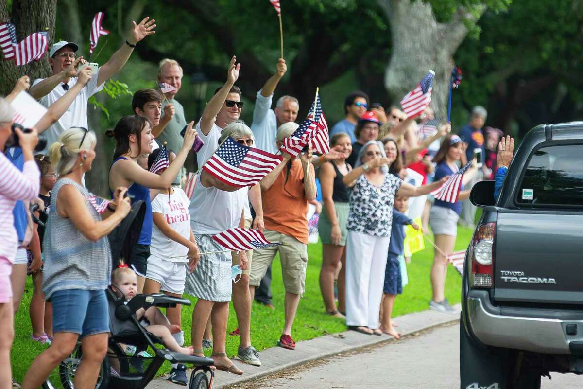Neighbors in the Timber Cove subdivision wave farewell to Astronaut Bob Behnken as he departs his Houston neighborhood for Florida for the upcoming launch of the SpaceX Falcon 9 rocket and Crew Dragon spacecraft, Wednesday, May 20, 2020, in Seabrook.
