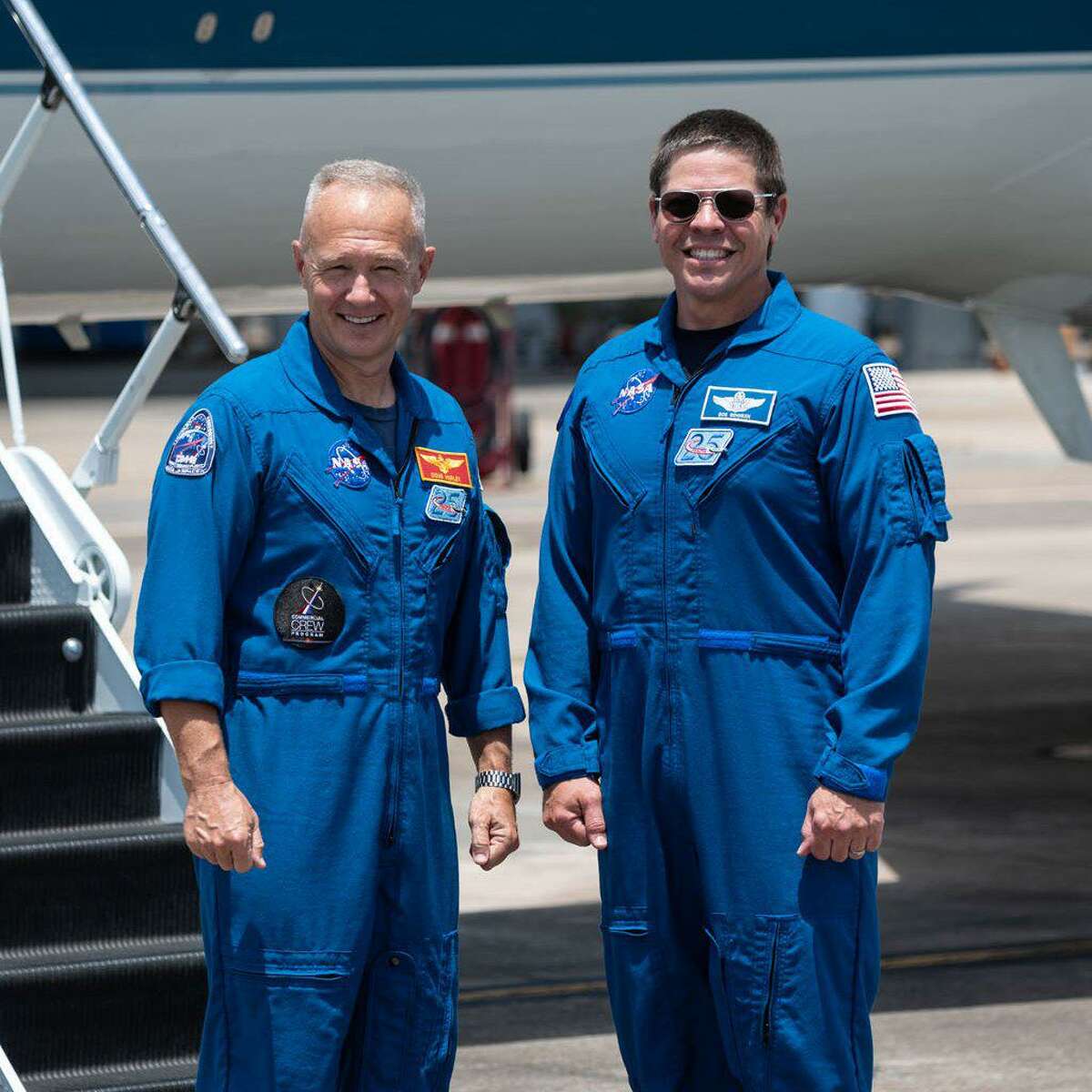 Astronauts Doug Hurley, left, and Bob Behnken at Ellington Airport on May 20, 2020. They are departing Houston for Kennedy Space Center in Florida, where they will launch into space on May 27 on a SpaceX Falcon 9 rocket and Crew Dragon spacecraft.