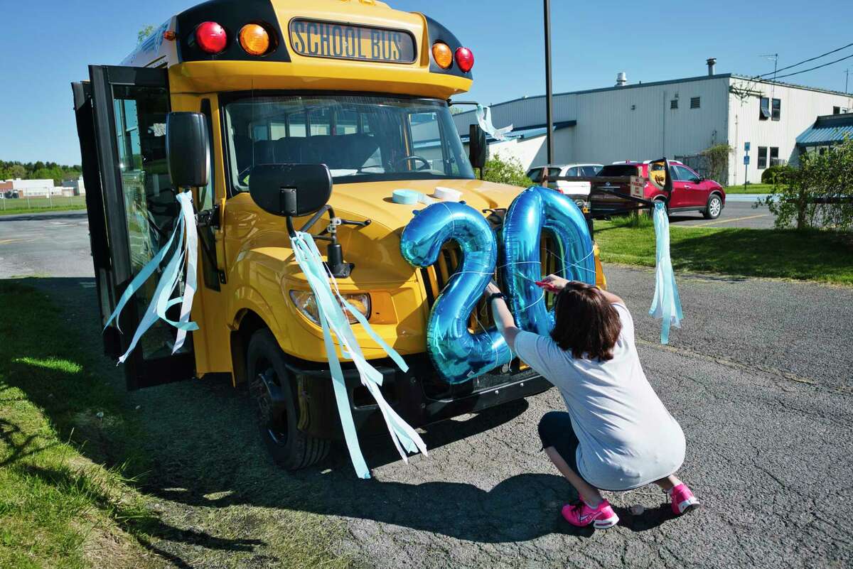 A study by researchers at the University of Texas at Austin predicts how many students may be infected with COVID-19 in the first week of school.  The results are based on overall infection rates in the county and are broken down by the size of the school.  East Greenbush School District school bus driver Carianne Rudolph decorates her bus which will lead a parade of cars filled with school teachers and staff on Wednesday, May 20, 2020, in East Greenbush, N.Y. (Paul Buckowski/Times Union)
