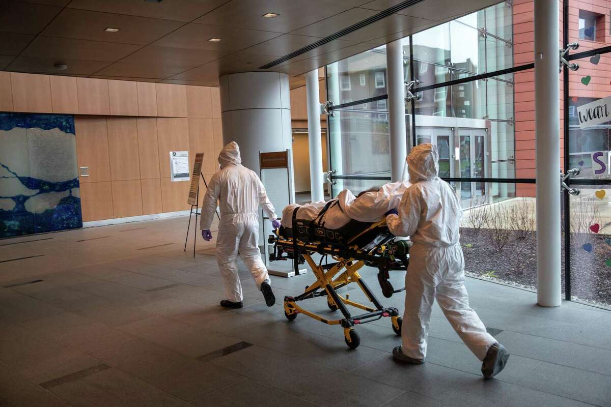 Medical staff transported a COVID-19 patient at Stamford Hospital in an April file photo.