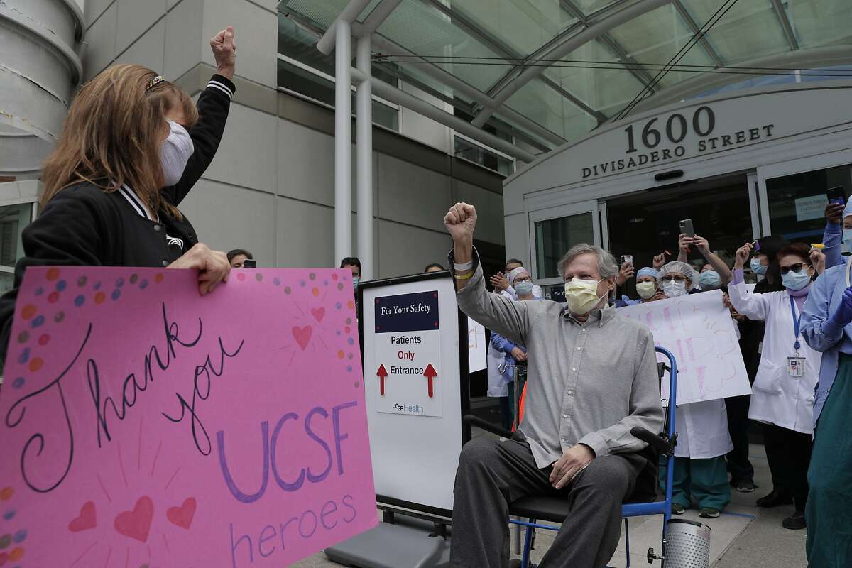 Ronald Jay Temko is cheered by family, friends and medical personnel as he is discharged from UCSF Mount Zion Hospital, after being hospitalized for over 61 days with COVID-19 in San Francisco. Calif., on Wednesday, May 20, 2020. Temko was in a coma for 21 days, on a ventilator for 34 days, and had a feeding tube for 40 days. Despite all the odds, he is now up and walking, as mentally sharp as ever, and beyond grateful to be alive. He will now get to walk his daughter down the aisle, hold his new baby granddaughter, and teach his grandson how to play golf.