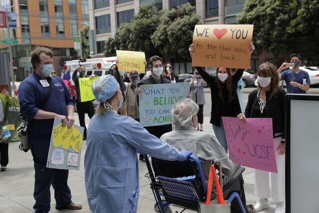 Ronald Jay Temko is cheered by family, friends and medical personnel as he is discharged from UCSF Mount Zion Hospital, after being hospitalized for over 61 days with COVID-19 in San Francisco. Calif., on Wednesday, May 20, 2020. Temko was in a coma for 21 days, on a ventilator for 34 days, and had a feeding tube for 40 days. Despite all the odds, he is now up and walking, as mentally sharp as ever, and beyond grateful to be alive. He will now get to walk his daughter down the aisle, hold his new baby granddaughter, and teach his grandson how to play golf.