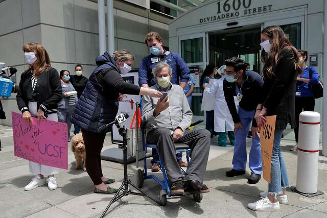 Ronald Jay Temko does a live video feed surrounded by family, friends and medical personnel as he is discharged from UCSF Mount Zion Hospital, after being hospitalized for over 61 days with COVID-19 in San Francisco. Calif., on Wednesday, May 20, 2020. Temko was in a coma for 21 days, on a ventilator for 34 days, and had a feeding tube for 40 days. Despite all the odds, he is now up and walking, as mentally sharp as ever, and beyond grateful to be alive. He will now get to walk his daughter down the aisle, hold his new baby granddaughter, and teach his grandson how to play golf.