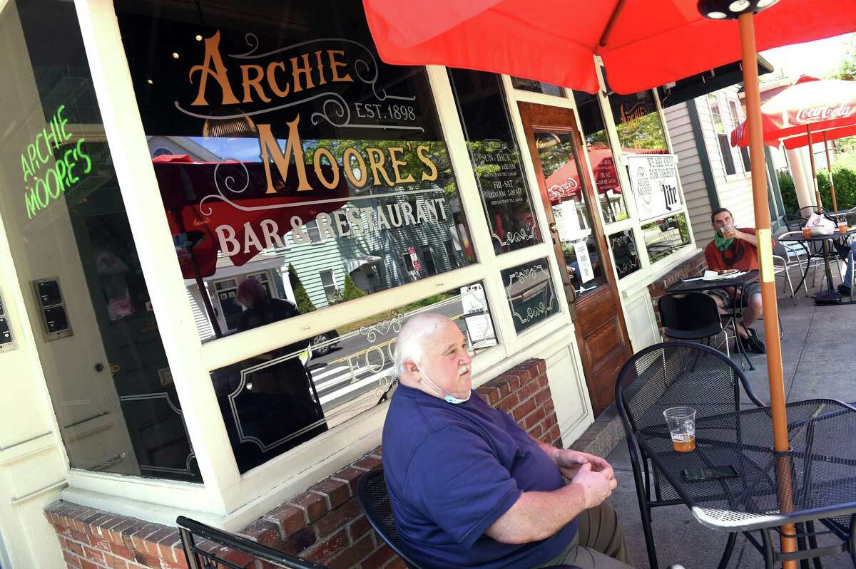 Bruce Suponski of New Haven takes advantage of the first day of the phased reopening of businesses in Connecticut to have lunch at Archie Moore's Bar & Restaurant's outdoor seating on Willow Street in New Haven on May 20, 2020.