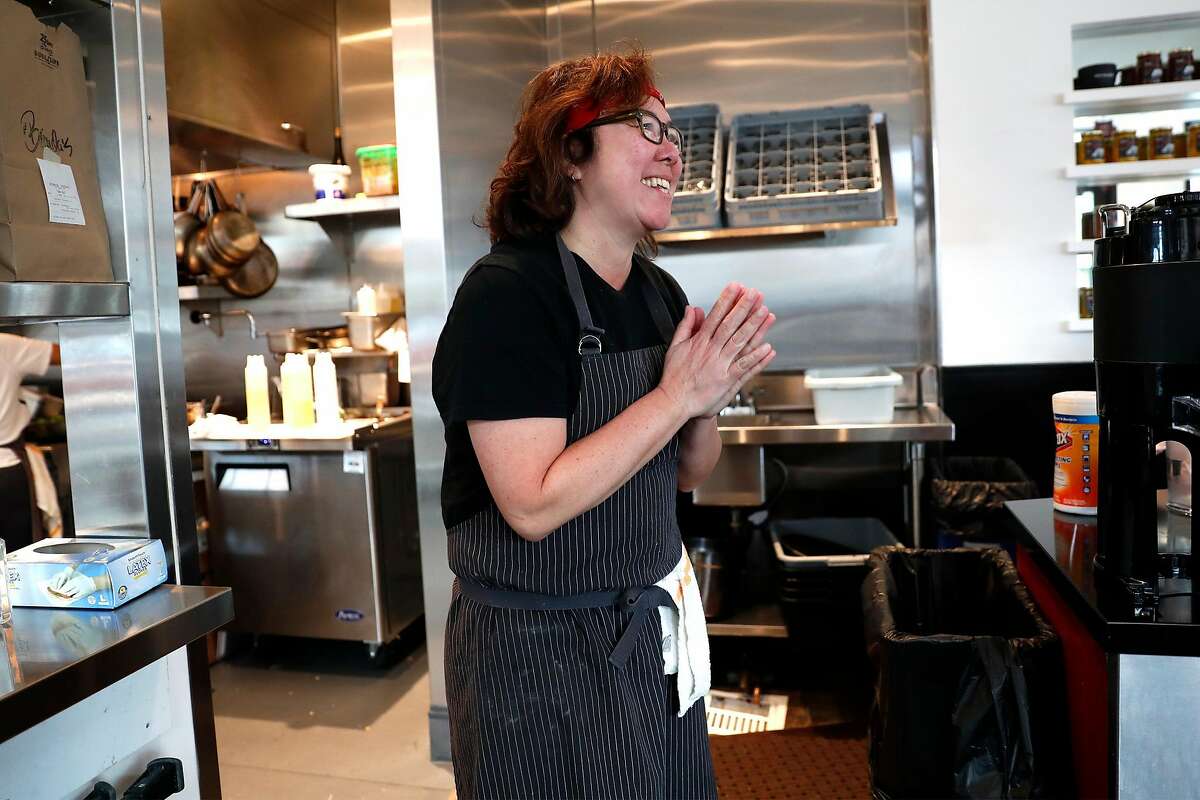 Owner Brenda Buenviaje thanks an employee at Brenda's in Oakland, Calif., on Wednesday, March 19, 2020.