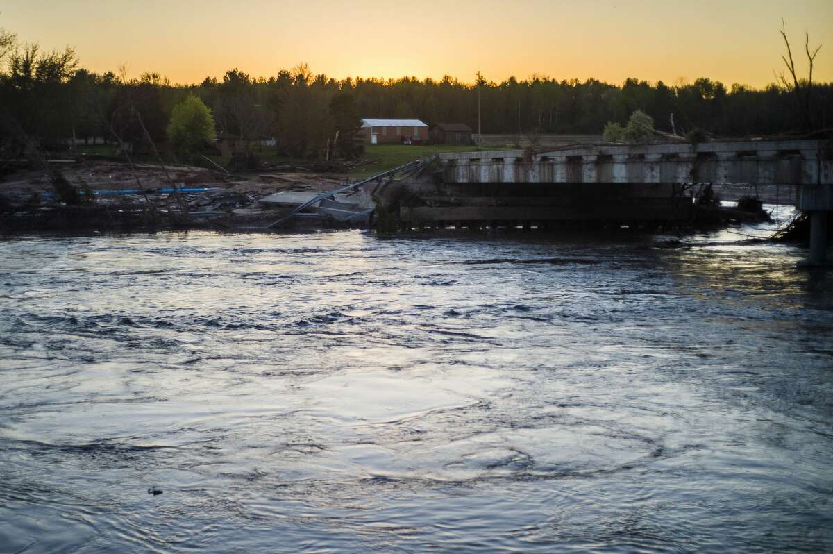 The sun sets over the West Curtis Road Bridge Wednesday evening, May 20, 2020, after it was destroyed by floodwater due to the failure of the Edenville Dam. (Katy Kildee/kkildee@mdn.net)