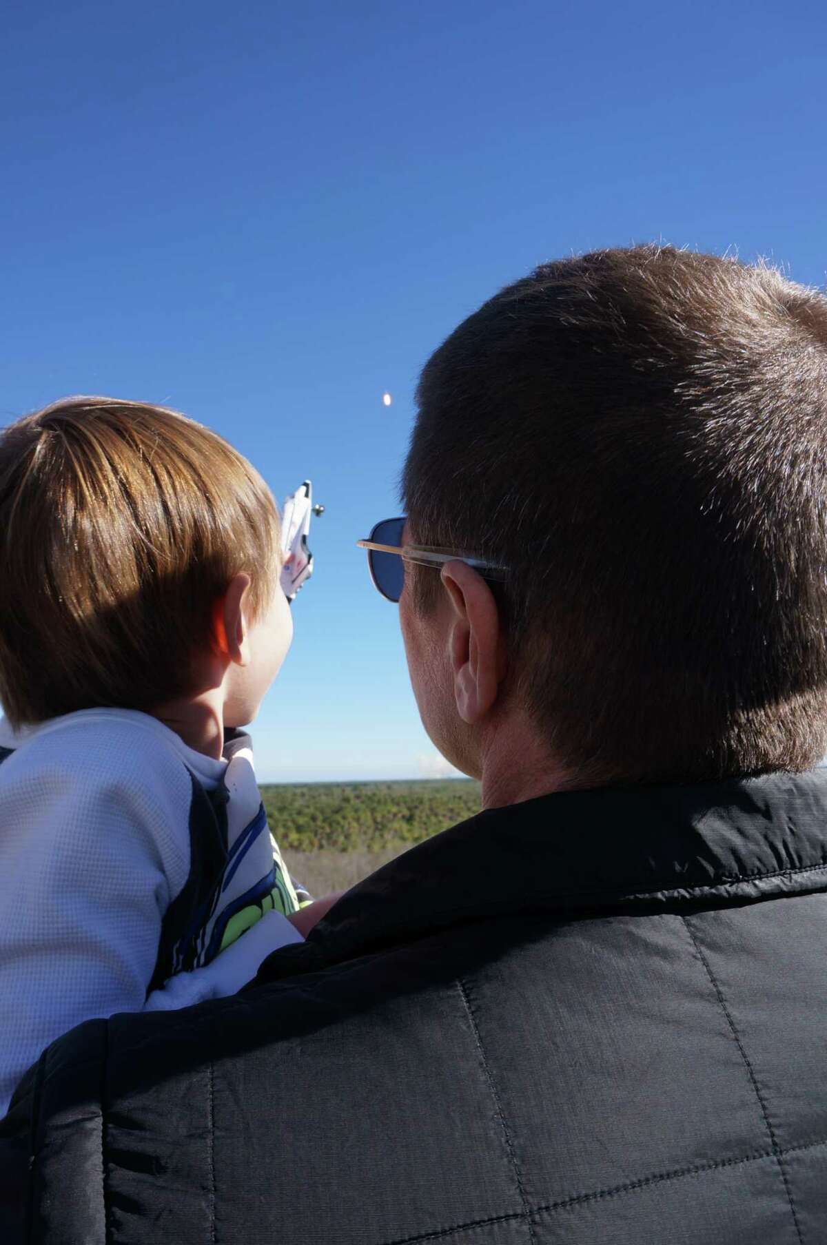 Astronaut Bob Behnken and his son Theodore watch a SpaceX rocket launch in December 2018.