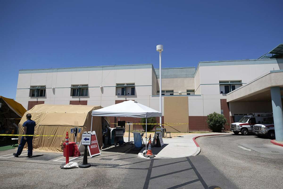 A tent sits in front of the El Centro Regional Medical Center to help process patients with symptoms related to the new coronavirus Wednesday, May 20, 2020, in El Centro, Calif. As much of California inches toward businesses reopening, this farming region on the state's border with Mexico is grappling with a spike in hospitalizations from the coronavirus that could inflict more pain on its perpetually struggling economy. (AP Photo/Gregory Bull)