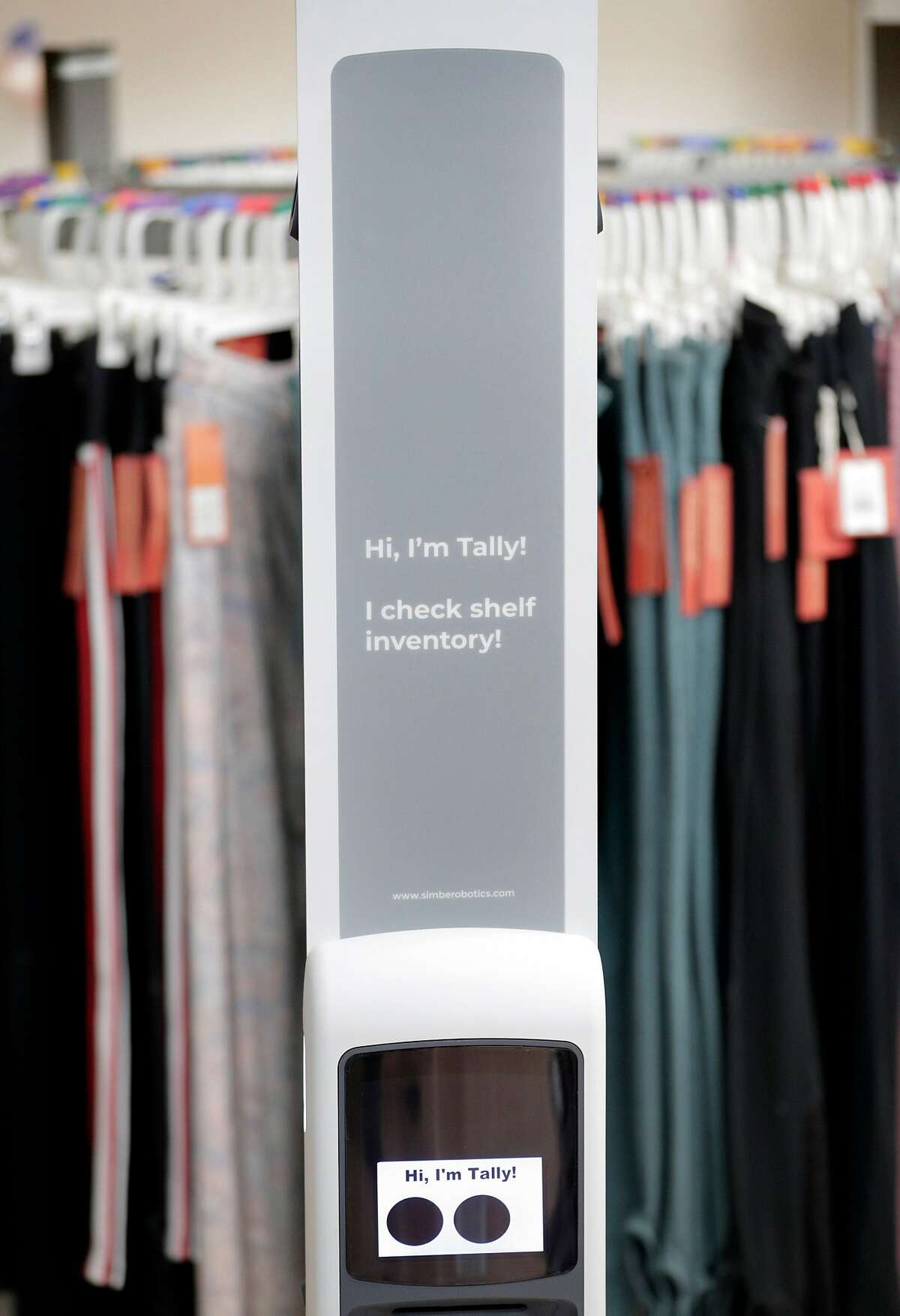 Tally, a robot for inventory management stands next to a rack of clothes it will scan using RFID in South San Francisco, Calif., on Tuesday, May 12, 2020. Tally, the robot scans stocked store shelves for products using cameras, LIDAR, and RFID to take a count of inventory.