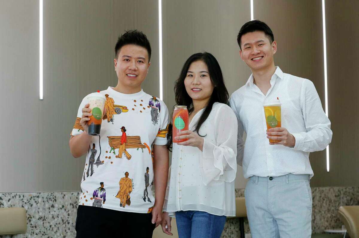 Yumcha Tea House and Bakery owners Jun Lin, left to right, Xiuqing Huang, and John Yang pose for a photograph inside their shop at Dun Huang Plaza on Tuesday, May 19, 2020, in Houston.