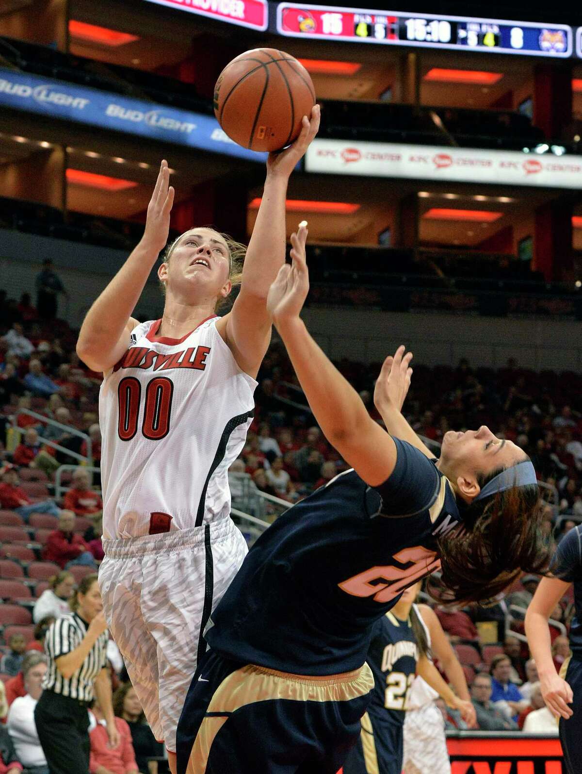 Louisville's Sara Hammond, left, gets a shot off over the defense of Quinnipiac's Brittany McQuain during the first half of an NCAA college basketball game, Monday, Nov. 11, 2013, in Louisville, Ky. (AP Photo/Timothy D. Easley)