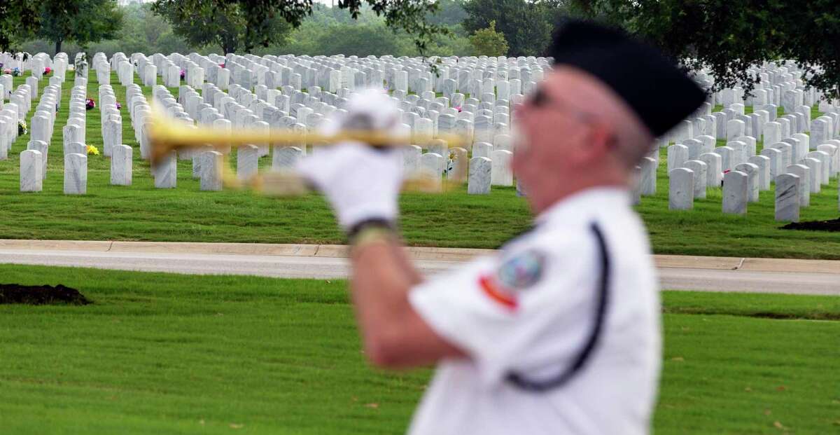 Mike Kinkade plays Taps Wednesday, May 20, 2020 during the Memorial Day ceremony at Fort Sam Houston National Cemetery. Due to the COVID-19 coronavirus the cemetery held the service without spectators.
