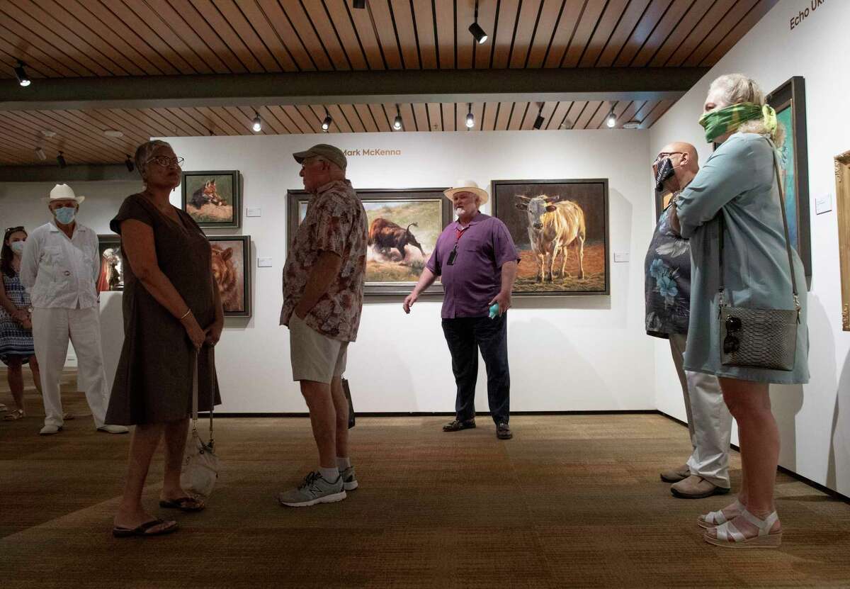 Michael Duchemin, president and CEO of the Briscoe Western Art Museum downtown, leads a tour on Thursday, as the museum reopened to members.