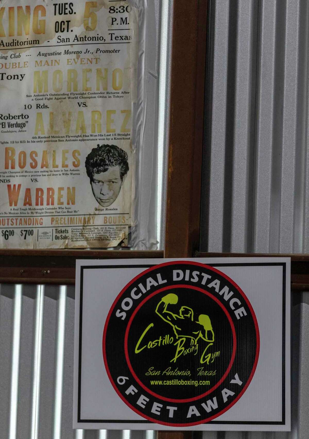 Social distancing signs hang Thursday, May 21, 2020, at Castillo's Boxing Gym on Pleasanton Road beside classic boxing posters to remind gym members to keep their distance from other members. Gyms are slowly starting to open as Texas has reduced COVID-19 coronavirus restrictions.