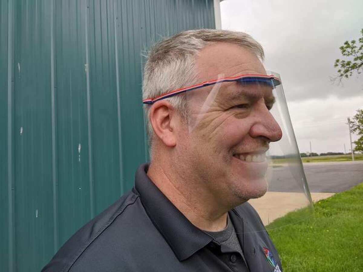 Tom Whitten, manager of the Lewis and Clark Community College’s St. Louis Confluence Fab Lab in Edwardsville, demonstrates a face shield using a plastic headband created by 3D printers at the lab.