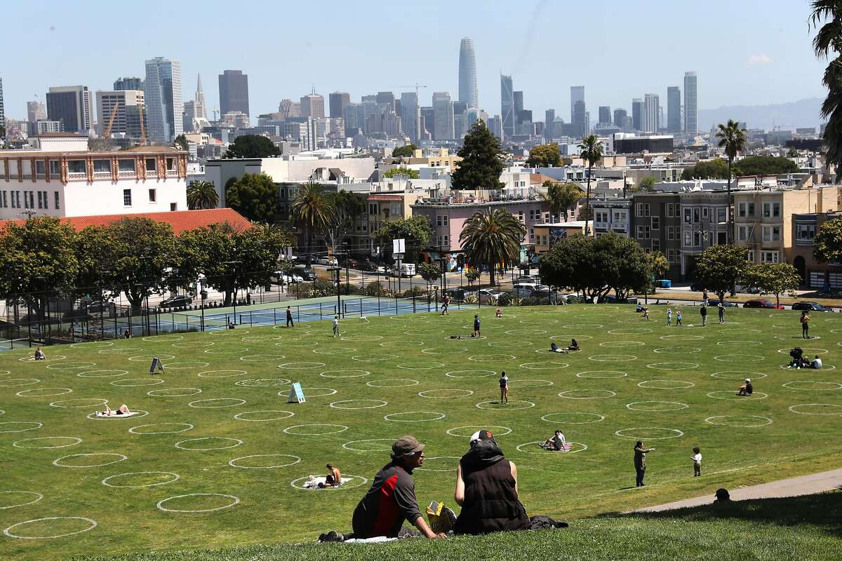 �Human parking spots" are marked at Mission Dolores Park seen during lunch time on Thursday, May 21, 2020, in San Francisco, Calif. San Francisco Recreation & Parks Department painted social-distance guidance circles on the parks lawn.