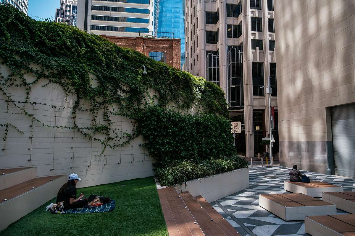People sit and socially distance in a very quiet downtown San Francisco on Thursday, May 21, 2020.