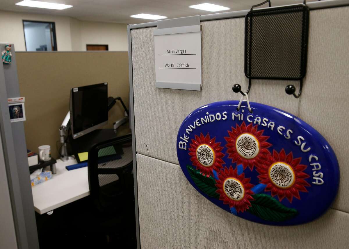 An interpreter who translates for Spanish-speaking patients meeting with their physicians on remote video appointments personalizes her cubicle at a Stanford Health Care call center who are in Palo Alto, Calif. on Tuesday, May 12, 2020.