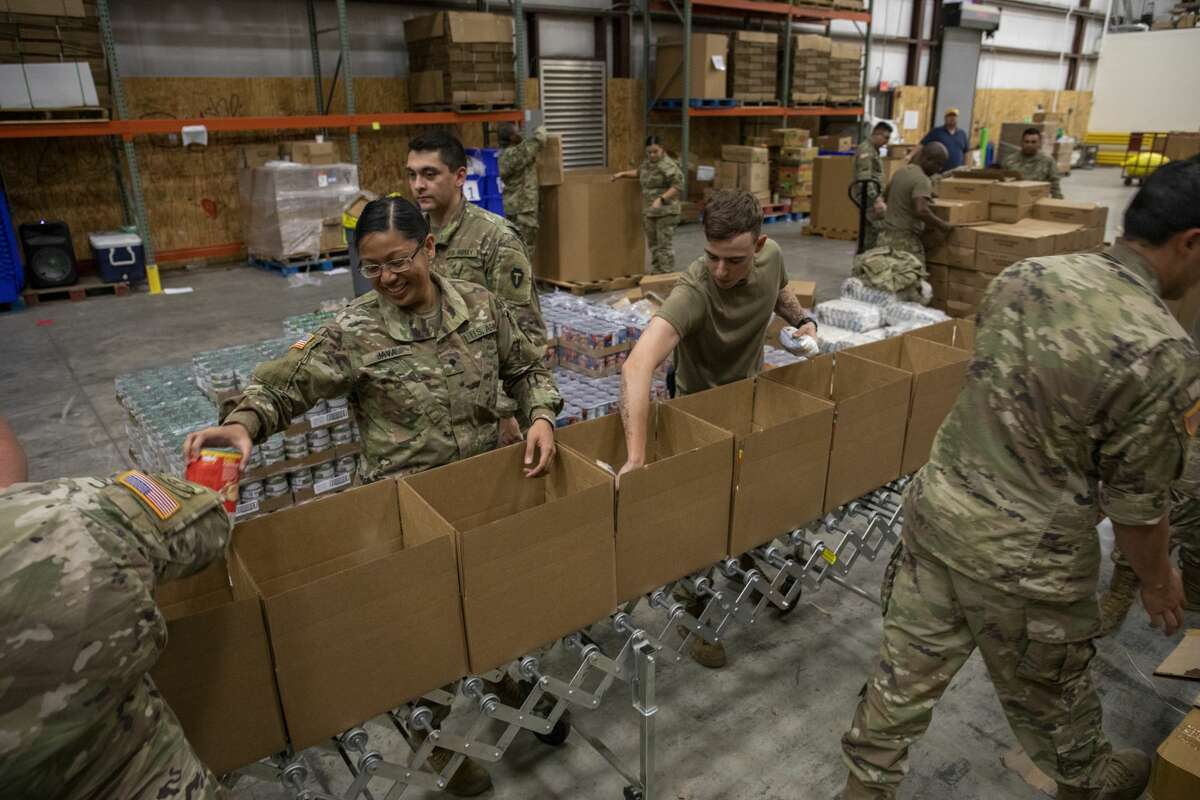 Members of the Texas Army National Guard build pantry boxes Tuesday, May 19, 2020 at the West Texas Food Bank in Odessa. Jacy Lewis/Reporter-Telegram