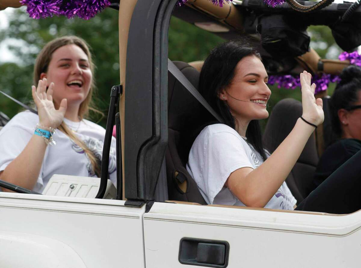 Courtney Baird, right, and Megan McClelland wave to teachers as they pass A.R. Turner Elementary School, Friday, May 22, 2020, in Willis.