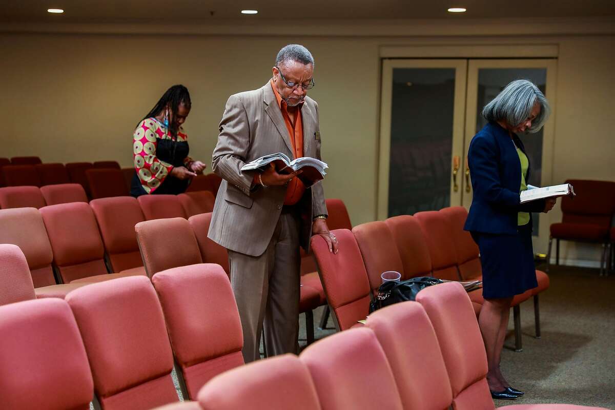 Lisa Reece (left) and Deacon Robert Lacy (center) during the virtual church service at Cornerstone Missionary Church in the Bayview district on Sunday, May 10, 2020 in San Francisco, California. One of the congregants, Tessie Henry, contracted coronavirus from a funeral at the church and later died.