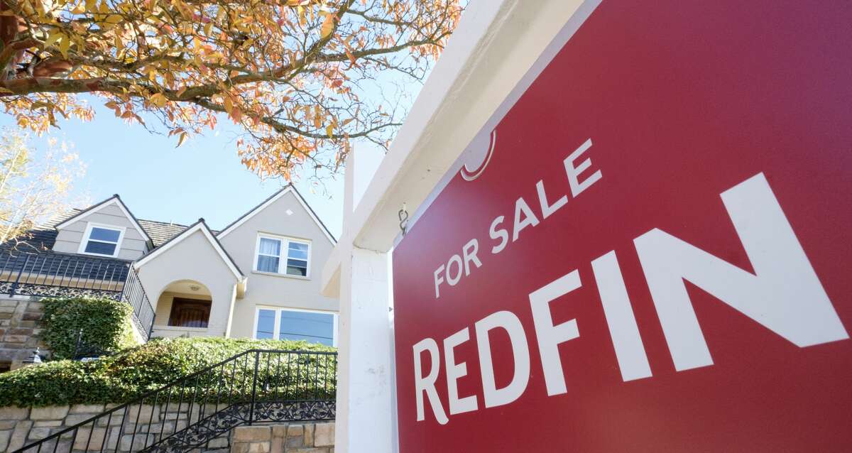 A Redfin real estate yard sign is pictured in front of a house for sale on October 31, 2017 in Seattle, Washington.