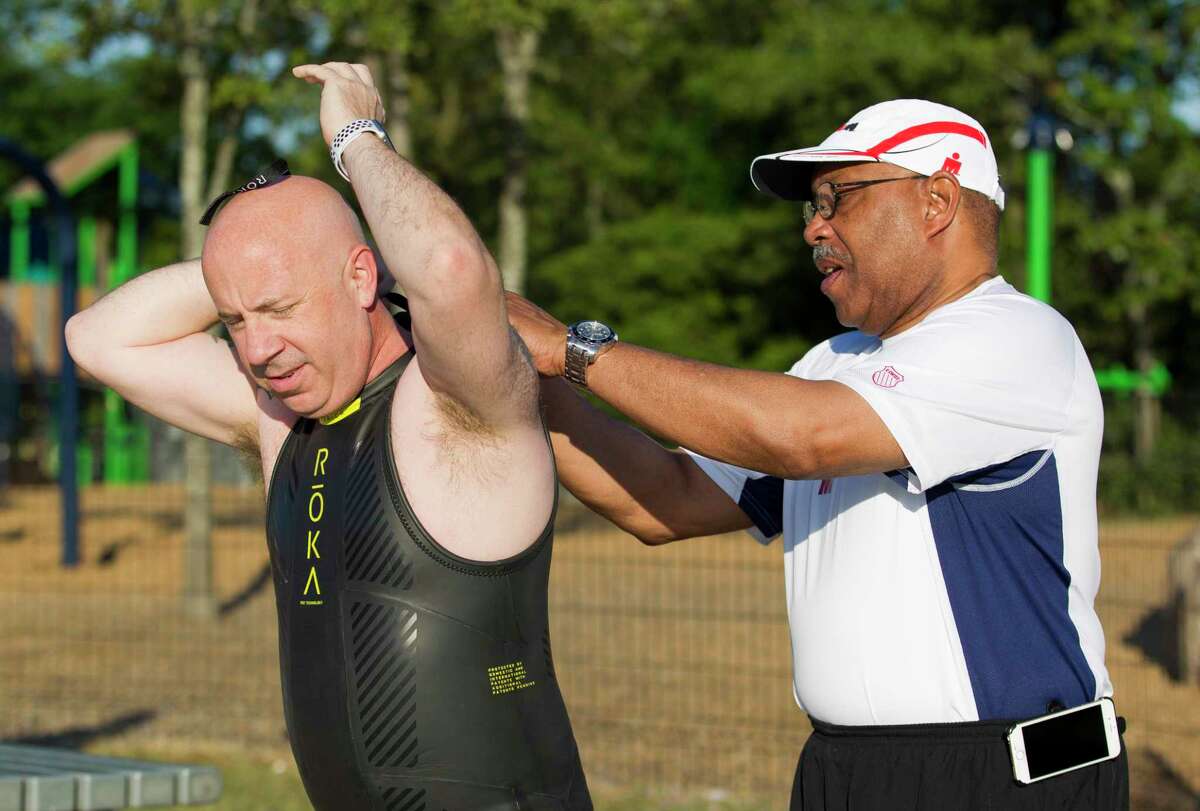 John Anthony Brown, board member with The Woodlands Township, puts on his wetsuit as triathletes prepare for the 2019 Ironman Triathlon competition at Northshore Park, Friday, April 26, 2019, in The Woodlands. A two-term incumbent, Brown became the second person to announce intention to seek a seat on The Woodlands Township Board of Directors, telling The Villager on Friday night he intends to seek his third term in office in the November 2020 election.