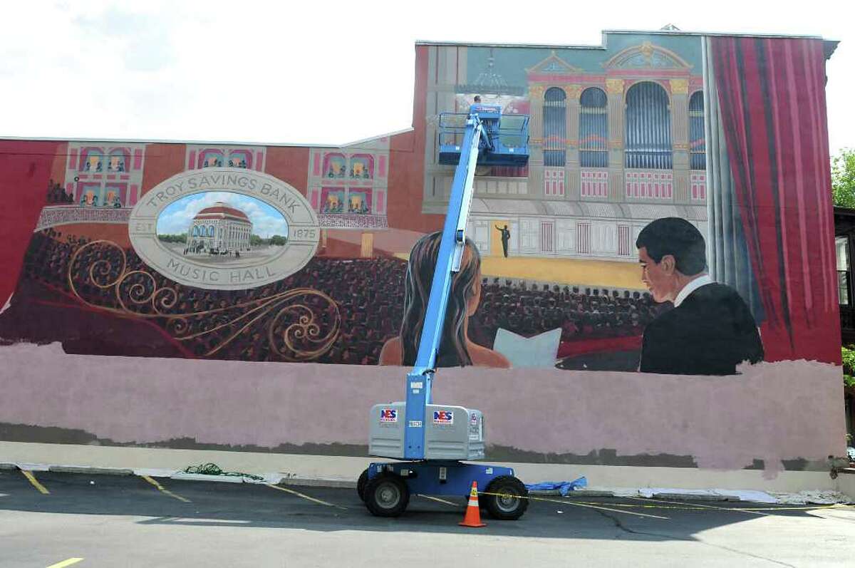 Muralist Kevin Clark works on a mural of the Troy Savings Bank Music Hall above the parking lot adjacent to the music hall and bank in Troy on Aug. 19, 2010. (Lori Van Buren / Times Union)