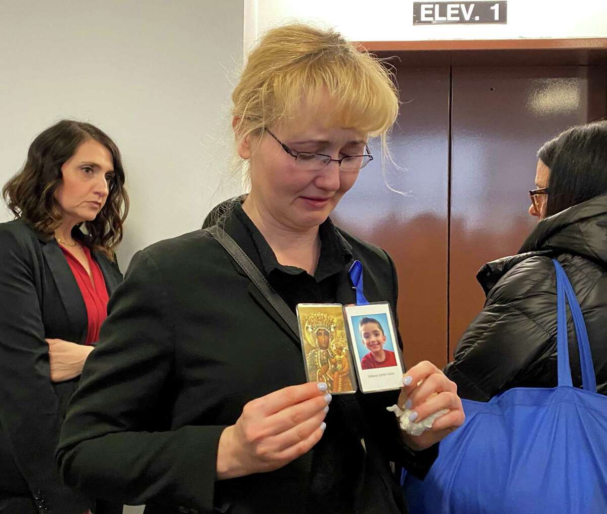 Riverhead, N.Y.: Justyna Zubko-Valva is pictured with a photo of her son Thomas Valva at the Arthur M. Cromarty Criminal Court Complex in Riverhead, New York on Feb. 6, 2020. Thomas Valva's father, Michael Valva, and his father's girlfriend, Angela Pollina, were arrested on Jan. 24, 2020. They are charged with second-degree murder of Thomas Valva, 8 years-old.
