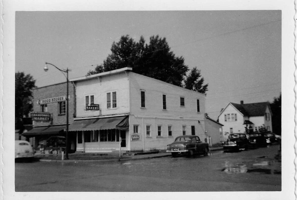 Corner of Clark St. and Benzie Boulevard, in Beulah early 1950's, showing the Crystal Bakery and Crawford's Market food store. (Courtesy Photo)