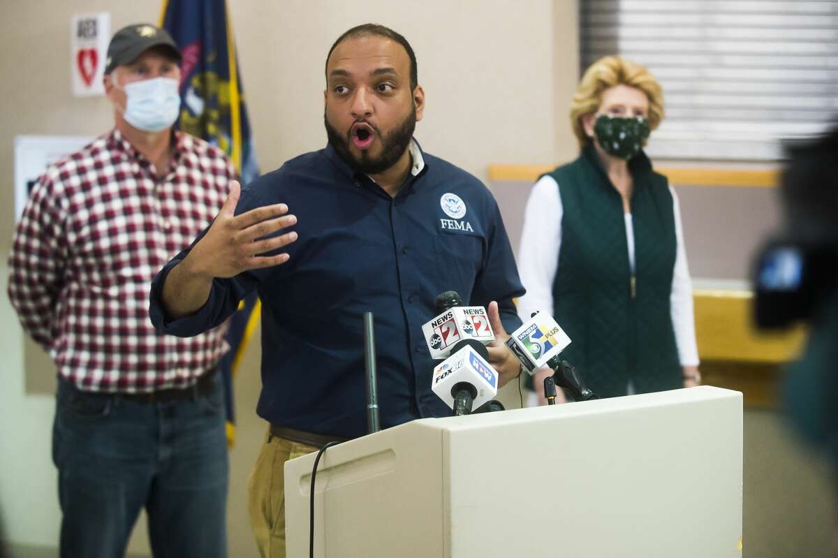 FEMA Regional Administrator James Joseph speaks during a joint press conference on flood recovery efforts as U.S. Rep. John Moolenaar, left, and U.S. Sen Debbie Stabenow, right, stand behind him Saturday, May 23, 2020 at the Law Enforcement Center in Midland. (Katy Kildee/kkildee@mdn.net)