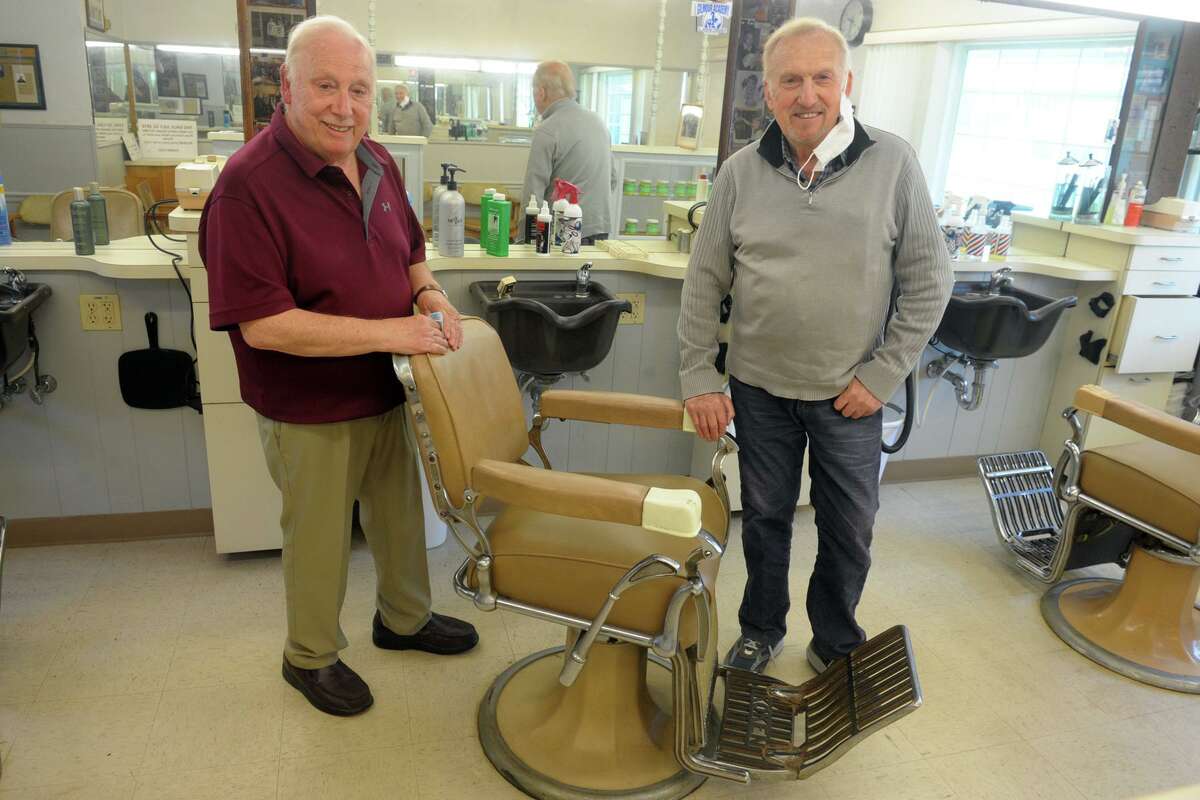 Brothers Tony, left, and Nick Clericuzio pose during an interview at Long Hill Hair Stylists, their barber shop in Trumbull, Conn. May 21, 2020. After 60-years in business, the brothers have both decided to retire.