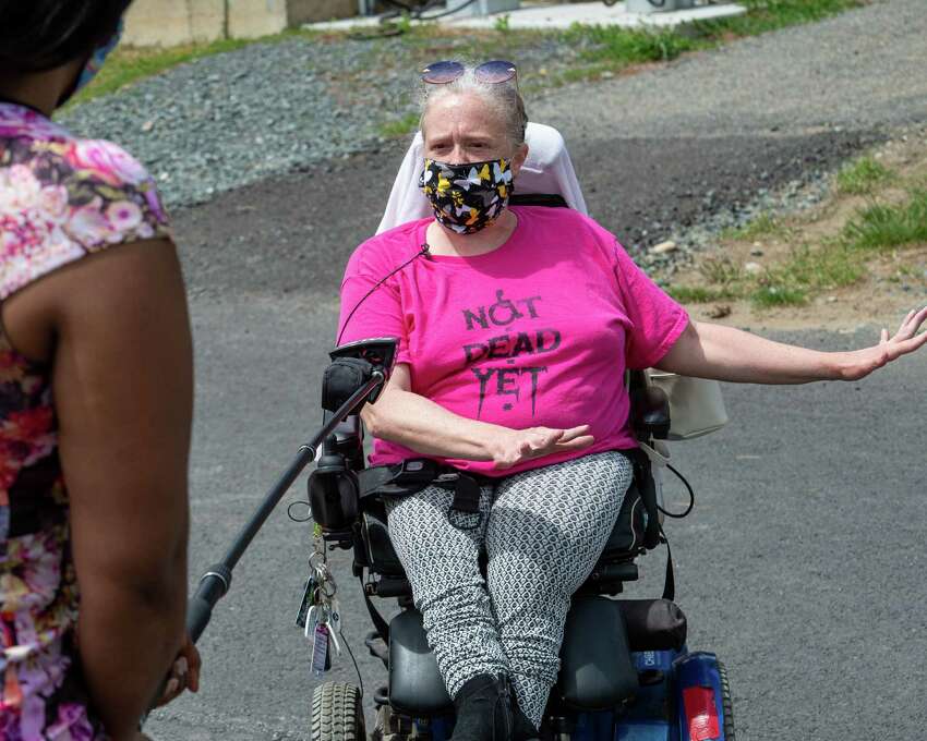 Jamie Farrar, of ADAPT Capital Region, answers questions during a vigil at Shaker Place Rehabilitation and Nursing in Colonie NY on Saturday, May 23, 2020 calling on New York state to support nursing home workers, transfer residents who so choose to safer settings and step up state regulations of nursing homes (Jim Franco/Special to the Times Union.)