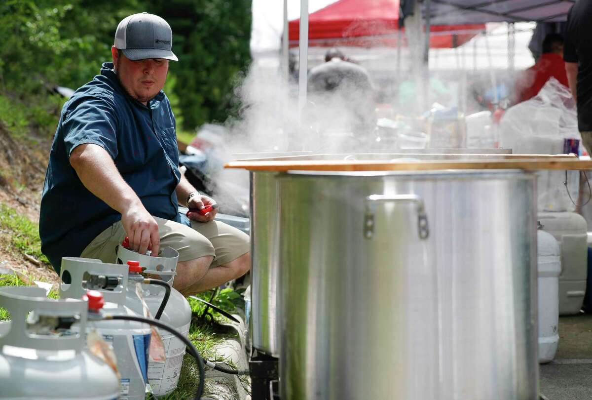 Ben Cling checks a propane tank for one of his team’s boils during the inaugural Crawfish Critic Cook-Off at Southern Star Brewing, Saturday, May 23, 2020, in Conroe.