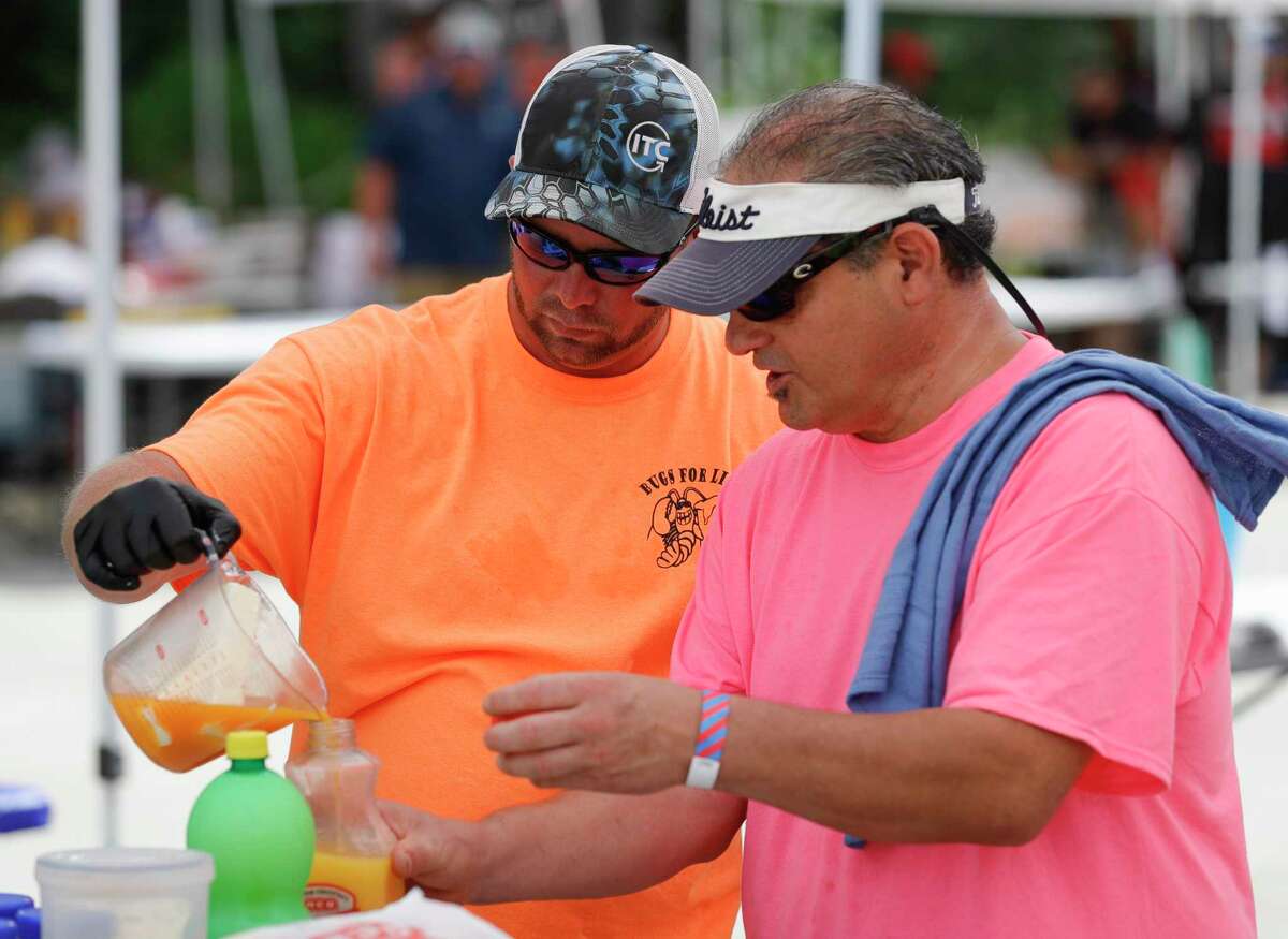 Mark Armendiz, right, and Jeremy Kraus measure out crawfish boil ingredients during the inaugural Crawfish Critic Cook-Off at Southern Star Brewing, Saturday, May 23, 2020, in Conroe.