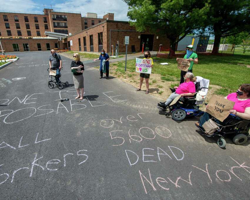Katy Carroll, of ADAPT Capital Region, speaks during a vigil at Shaker Place Rehabilitation and Nursing in Colonie NY on Saturday, May 23, 2020 calling on New York state to support nursing home workers, transfer residents who so choose to safer settings and step up state regulations of nursing homes (Jim Franco/Special to the Times Union.)