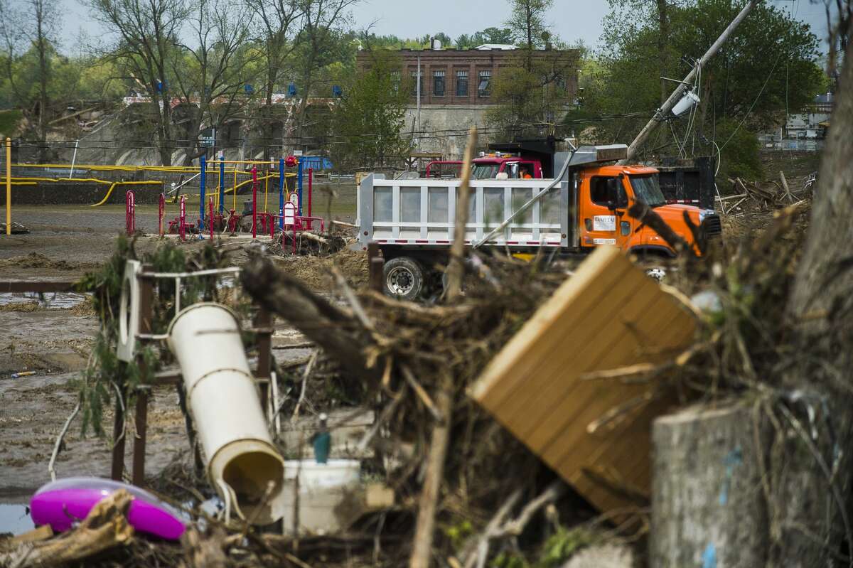 Sanford residents and business owners continue to clear debris, water and mud from the downtown area Saturday, May 23, 2020. (Katy Kildee/kkildee@mdn.net)