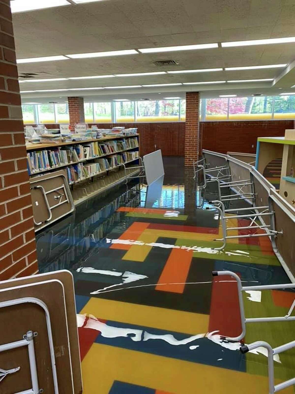 Water streams into the lower level of the Grace A. Dow Memorial Library on Thursday, May 21. (Photo provided/Facebook)